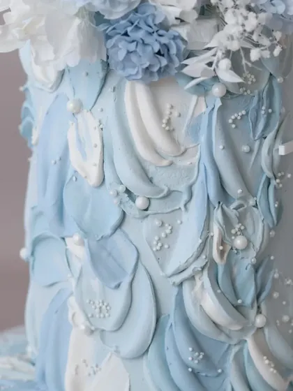 A detail shot of the textured, petal-like buttercream effect, dotted with delicate sugar pearls.
