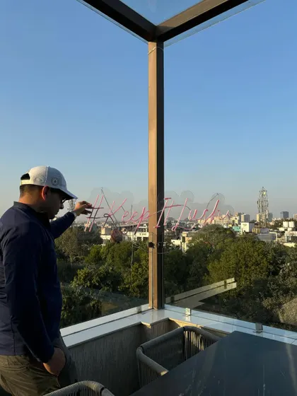 Setting up the signature '#KeepItLush' neon sign against the Delhi skyline. Every detail is considered to make the space feel special and on-brand for the Lush Loft experience.
