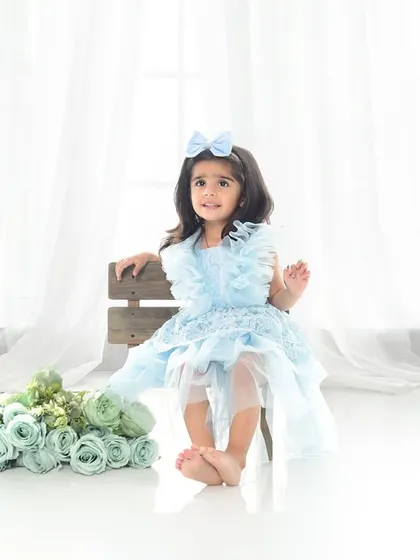 A princess in blue for her third birthday. This simple, elegant setup with a high-key white background lets her beautiful dress and personality shine.