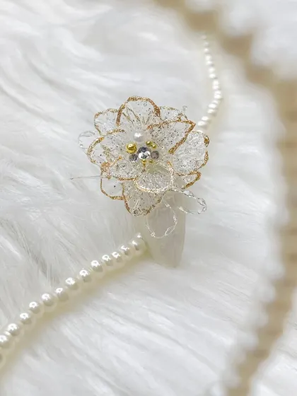 An exquisite 3D flower created with molding gel. The delicate, translucent petals are outlined in gold glitter, creating a luxurious and ethereal look.