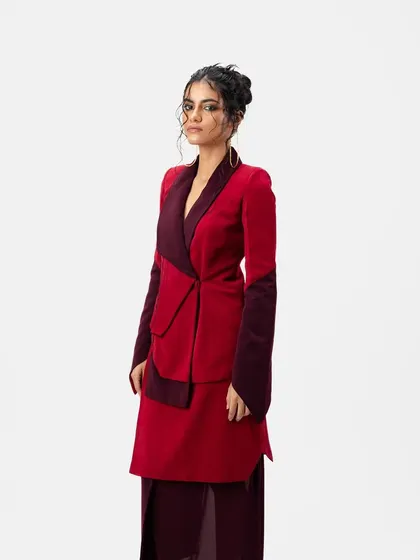 A three-quarter view of the designer look. The messy, textured updo is visible from the side, adding interest and dimension to the silhouette.