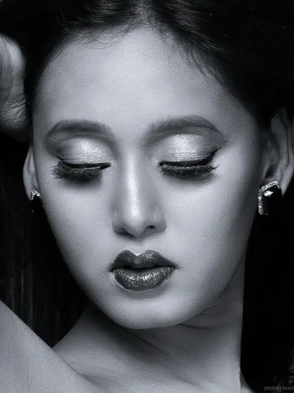 A soulful black and white close-up, highlighting the glittery eyeshadow and dramatic winged liner. This edit adds a classic, emotive quality to the beauty portrait.