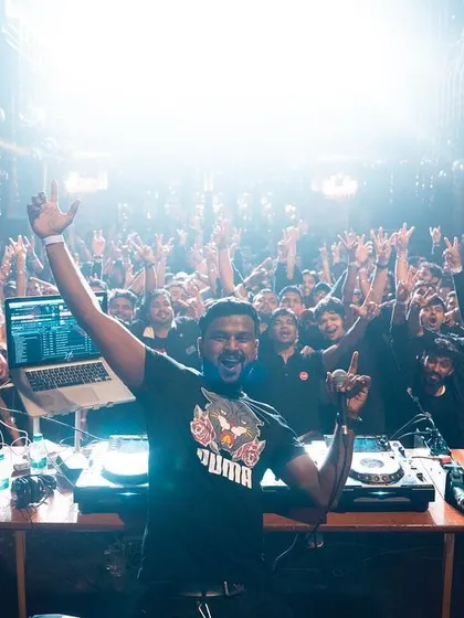 A packed house with hands in the air is the ultimate goal. This photo from a large club event shows the kind of atmosphere I bring, which translates perfectly to making corporate parties feel less corporate and more like a real celebration.