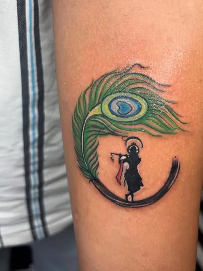 Another angle of the Krishna tattoo, showing how it wraps cleanly on the arm. Placement is key for a tattoo to look its best.