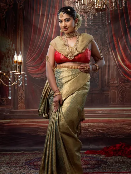 This image captures the regal essence of a South Indian bride. The makeup highlights her features while the traditional attire completes the look.