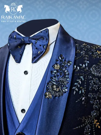 Another detailed shot of the navy blue tuxedo, highlighting the contrast between the satin lapel, the white shirt, and the sparkling embellishments.