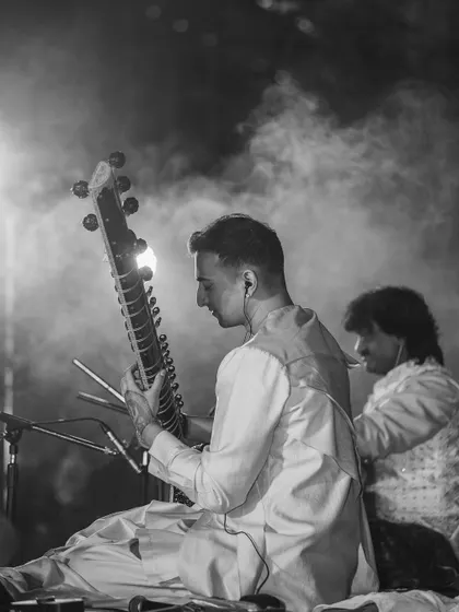 A black and white shot of me performing with a tabla player, capturing the timeless essence of a classical duet.