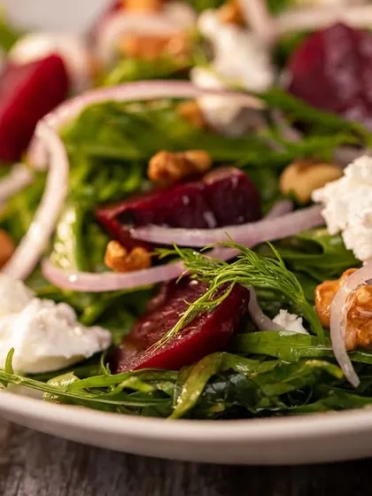 For a healthy and delicious option, try our smoked beetroot salad. It features earthy beetroot, crunchy walnuts, and crumbles of our fresh ricotta over a bed of greens.