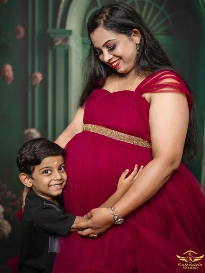 A joyful portrait of a mother and her son. His happy smile as he hugs the baby bump is absolutely priceless.