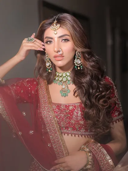 Here, I styled a classic red lehenga with a contemporary twist. The focus is on the stunning emerald and polki jewelry from Nirakara Jewels, which provides a beautiful contrast against the red, creating a look that is both traditional and fresh.