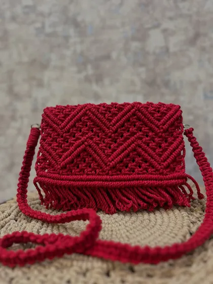 A full shot of the red chevron sling bag. It's a perfect accessory for festivals or a casual day out.