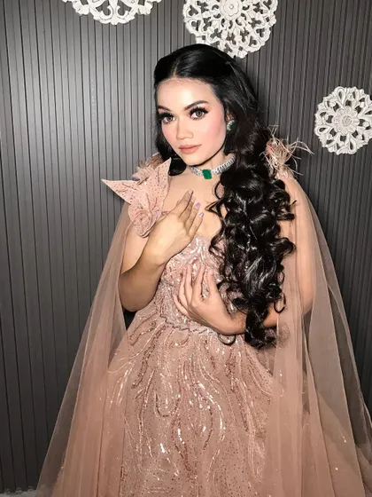 The cape adds a touch of drama to this beautiful pink gown, making it a real showstopper.