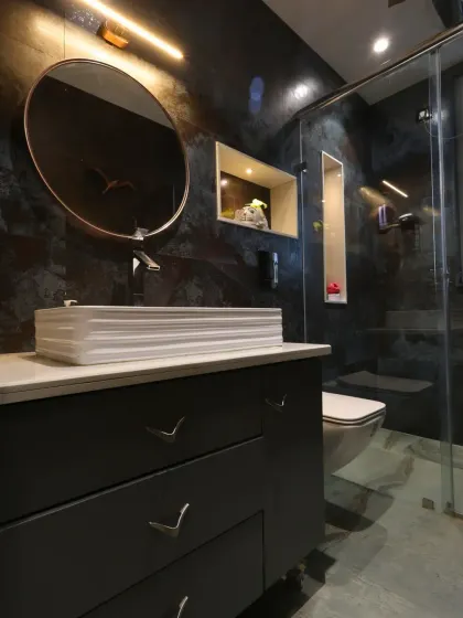 Another angle of the vanity, showing the warm lighting and the unique V-shaped handles on the drawers.
