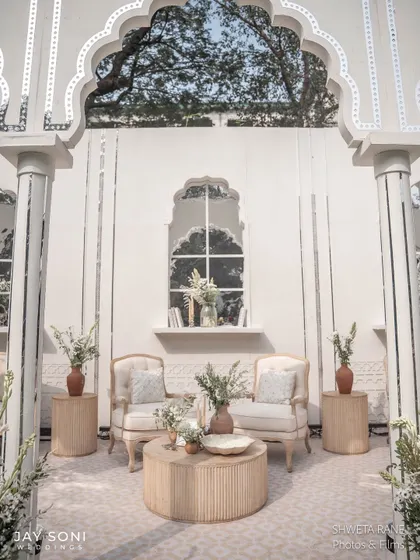 A perfectly symmetrical seating arrangement within one of the arched alcoves, creating a sense of order and calm elegance in the lounge area.
