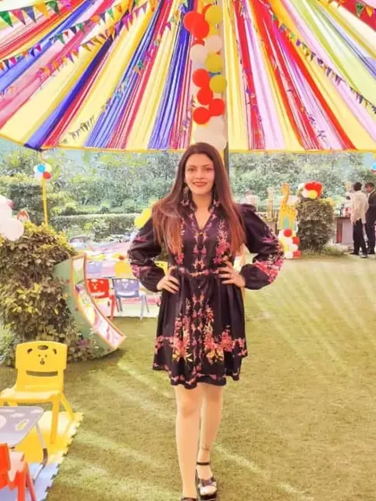 Our event host posing at a colorful outdoor kids' carnival. A good emcee or game coordinator is key to making sure the event runs smoothly and everyone has a great time.
