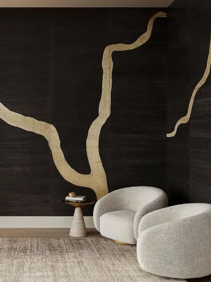 The 'Adorn' wallcovering by Phillip Jeffries, inspired by Kintsugi. The large-scale metallic branch design on a dark, textured background channels strength and uniqueness, creating a space that resonates with timeless beauty.