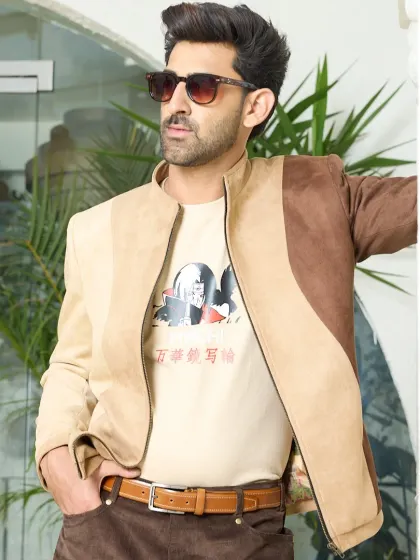 Suede sophistication with a bold twist. This two-toned tan and brown jacket brings earthy tones to life with its smooth texture and standout asymmetrical paneling.