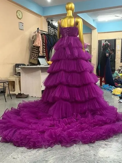 Another view of the purple ruffled gown, showcasing its incredible volume and the detail in the corset back. This is a true princess gown for your special shoot.