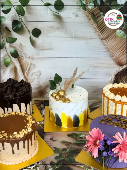 A beautiful spread of our diverse cake offerings. From a rich Nutella drip cake to a vibrant purple floral cake, this photo shows that we truly have a cake for every mood and moment.