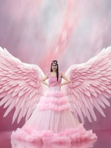 A stunning portrait with our pink ruffle gown and digitally added wings. This is a great example of how we can create fantasy-themed shoots in our studio.