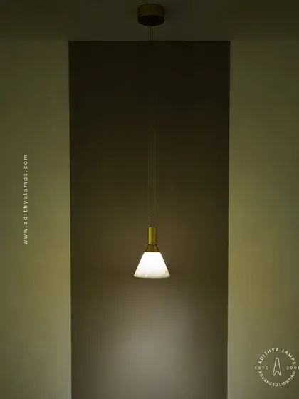 A simple yet elegant cone-shaped pendant light. The shade is crafted from marble, providing a warm, diffused downlight that is perfect for task lighting over kitchen counters, reading nooks, or as accent lighting.