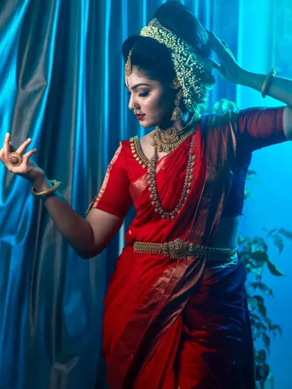 A series dedicated to capturing a divine, traditional look in a striking red saree. These images, shot both in-studio and outdoors, focus on graceful poses and the vibrant color of the attire.