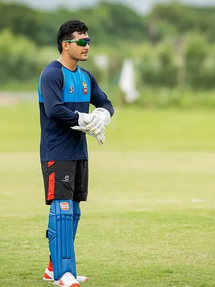 A wicketkeeper getting ready for action. My training ensures every player, regardless of their role, is in peak physical condition.