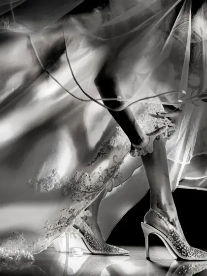 A duplicate of the award-winning shoe shot (ID 22), this artistic photo focuses on the details of the bride's attire with dramatic lighting.