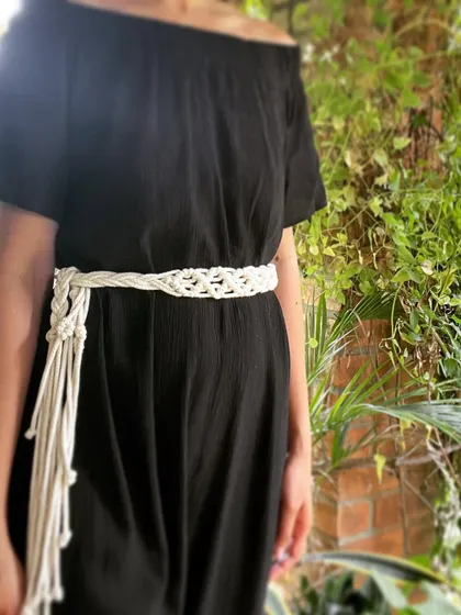 Here is the patterned macrame belt styled on a black jumpsuit. The long fringe can be tied in a knot or left to hang, giving you different styling options.
