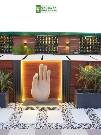 A close-up of the unique hand-shaped sculpture with integrated lighting, a standout feature of the Palam Vihar terrace.