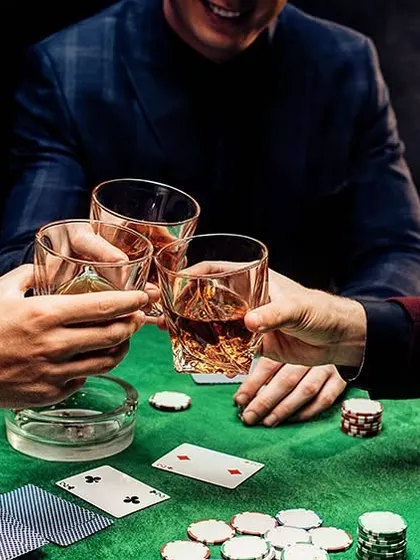 A cheers over a game of cards during a Diwali party. We ensure the drinks keep flowing so the good times don't stop, whether it's a poker night or a festive celebration.