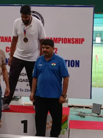 A competitor stands proudly on the first-place podium after receiving his medal during the ceremony.