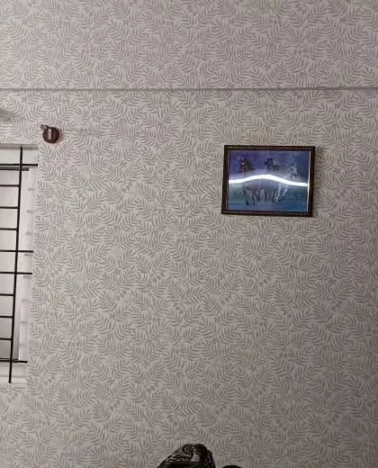 A room with a subtle grey wallpaper featuring a faint leaf pattern, adding texture without being overwhelming.