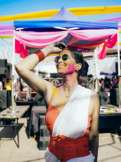 A guest enjoying the sun and vibes at our rooftop Holi party. The unique venue offers stunning views alongside the festive fun.