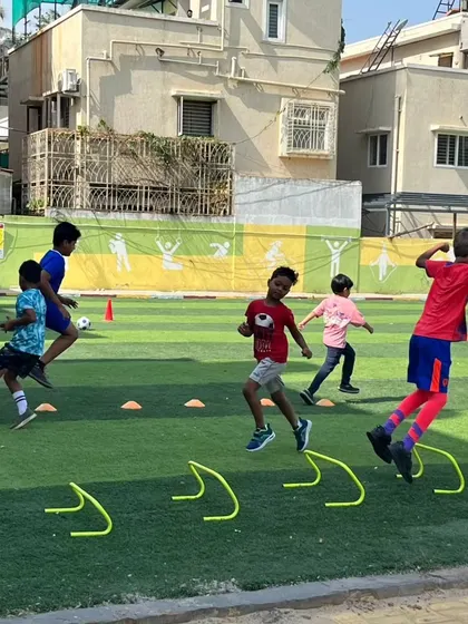 Young players engage in agility drills with hurdles, an essential part of our fitness and conditioning program.