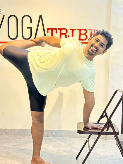 A happy moment while demonstrating a variation of Natarajasana with a chair. Yoga should bring a smile to your face.