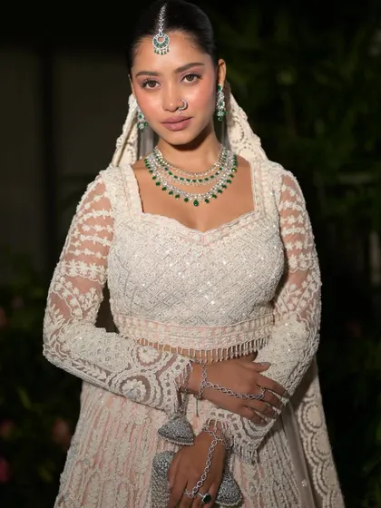 A full-length shot showing the complete, breathtaking look. The bride radiates grace and beauty from head to toe.
