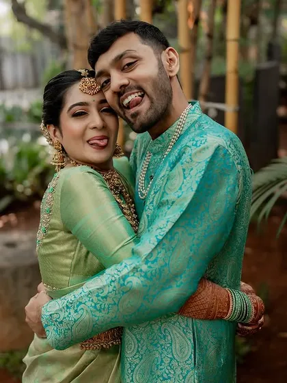 A day filled with endless smiles and laughter. We capture the fun, quirky moments that make your relationship unique, like this playful pose between the happy couple.