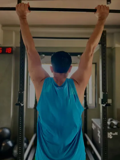 Working on pull-ups, a fundamental bodyweight exercise for building a strong back and arms. It's all about quality reps.