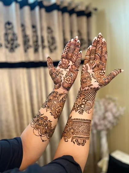 A beautiful and delicate floral vine design that wraps around the hands and arms.