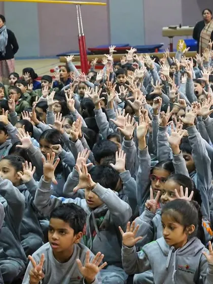 Look at all those hands in the air. This is what active participation looks like. During a winter morning session at Suncity School, the students were so engaged, singing along and eager to be part of the story.