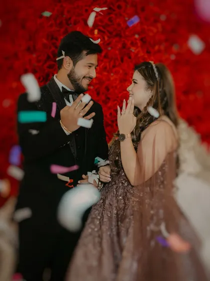 A moment of pure joy as the couple exchanges rings under a shower of confetti. We capture the peak of the celebration and their ecstatic expressions.