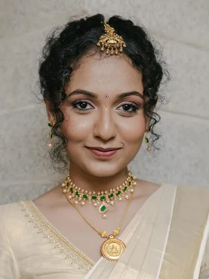 Subtle makeup for the cutest bride's engagement. Her natural curls are styled in a beautiful updo, and the makeup enhances her lovely features.