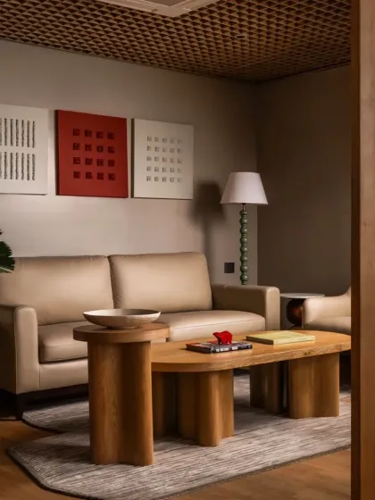 The waiting lounge at our Ulsoor office project. We used a palette of warm wood, neutral tones, and a striking red art piece to create a space that is welcoming, sophisticated, and rooted in the local context of Old Bangalore.