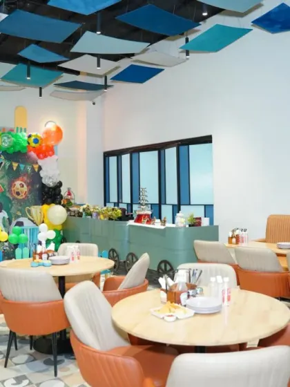 Our cafe area is fully decorated for a football-themed party, with a personalized birthday banner and coordinated table settings.