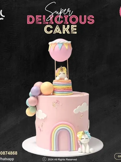 A whimsical unicorn cake featuring a hot air balloon. This magical design includes a cute unicorn floating in a balloon, another at the base, and a sweet rainbow arch, all in soft pastel colors.