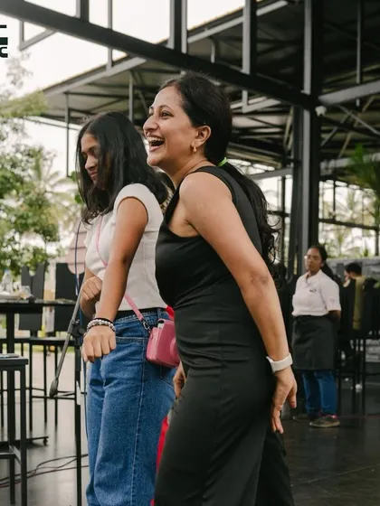 A mother and daughter sharing a laugh and a dance, creating beautiful memories.