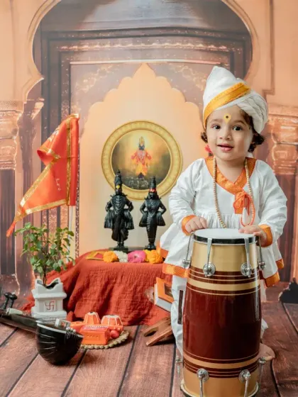 A bright smile makes this portrait with the drum especially heartwarming.