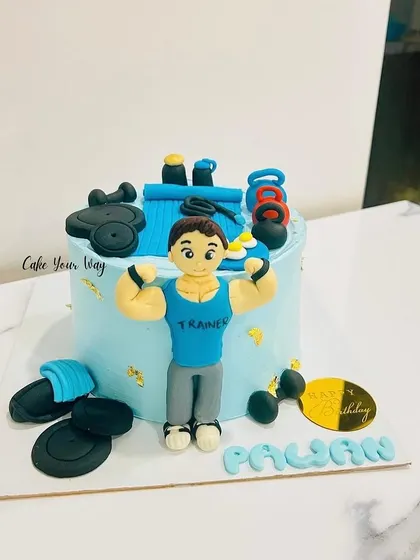 Flexing into another year with this gym-themed cake, complete with a fondant trainer and weights.