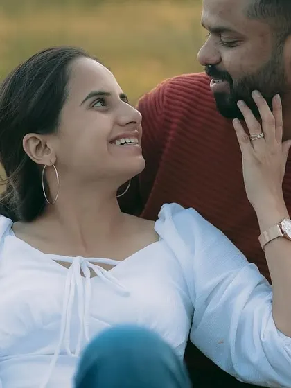A candid interaction during a picnic shoot, capturing genuine smiles and affection.